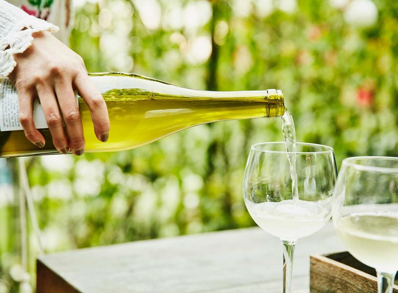 Pouring white wine in Queenstown, New Zealand