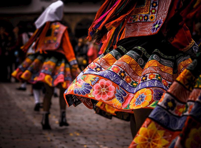 Women in traditional clothing dancing in Sacred Valley, Peru