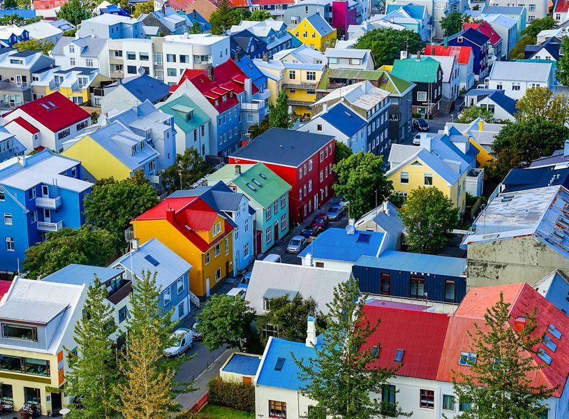 Aerial view of colourful rooftops and tree-lined streets in Reykjavik