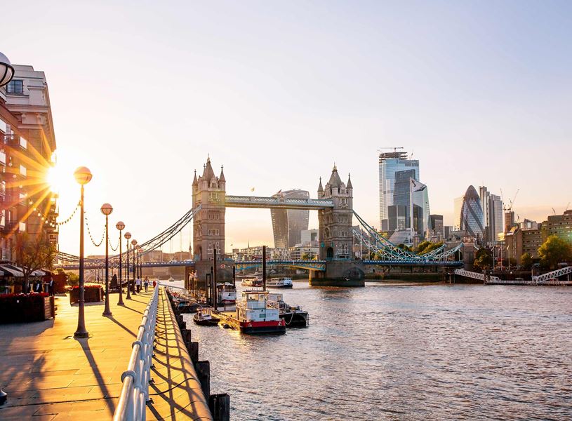 A scenic view of a riverside walkway and river in London, England