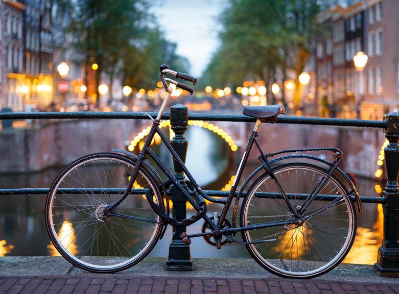 Bike by canal in Amsterdam, Netherlands