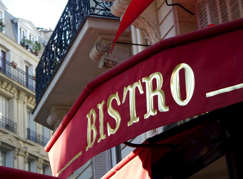 Red Café Bistro awning with gold lettering in Paris, France