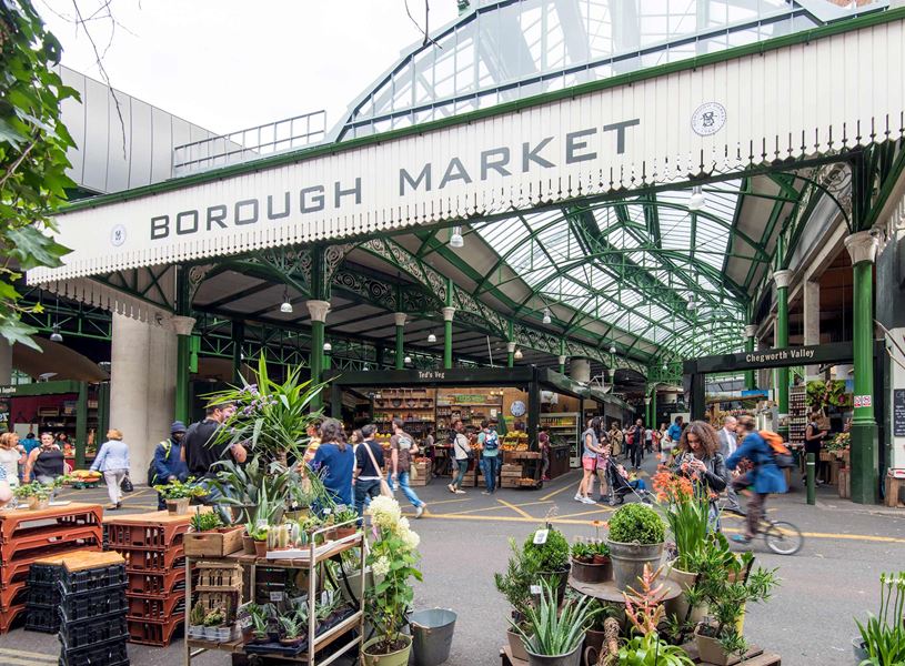 Entrance to Borough Market with shoppers and stalls in London