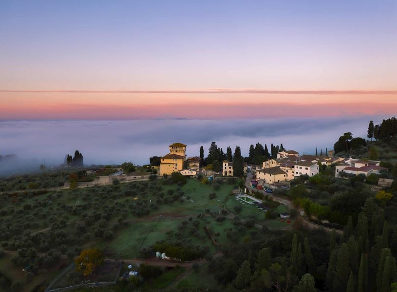 Tuscan hilltop village surrounded by olive groves 