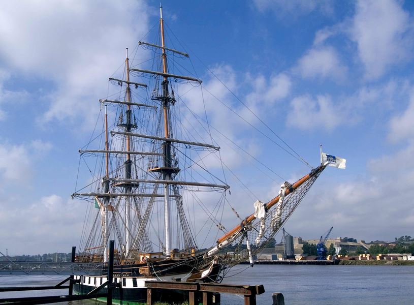 Dunbrody Famine Ship docked on River Barrow under blue sky in New Ross