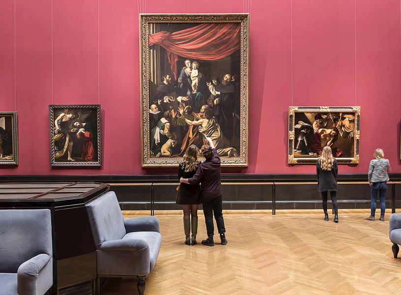 Visitors observing art at the Kunsthistorisches Museum in Vienna, Austria