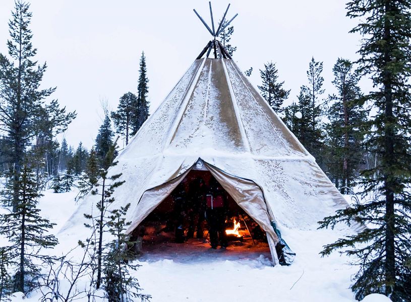 Meal with reindeer herder at family homestead in their lavvu (tepee), Kiruna, Sweden