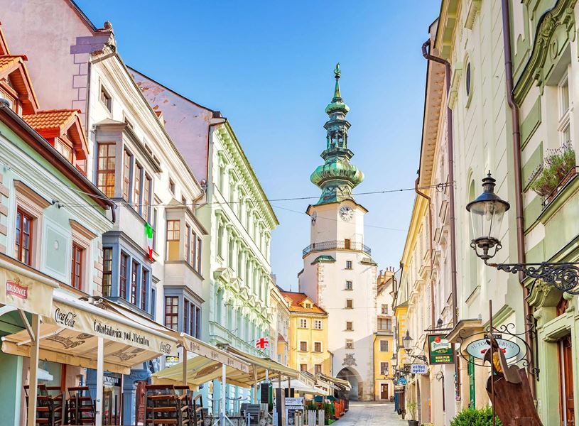 Michael’s Gate tower in Bratislava Old Town surrounded by colourful buildings and cafes