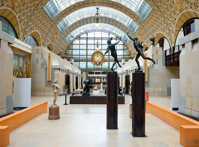 Musée d'Orsay hall with sculptures, glass ceiling and central clock in Paris, France