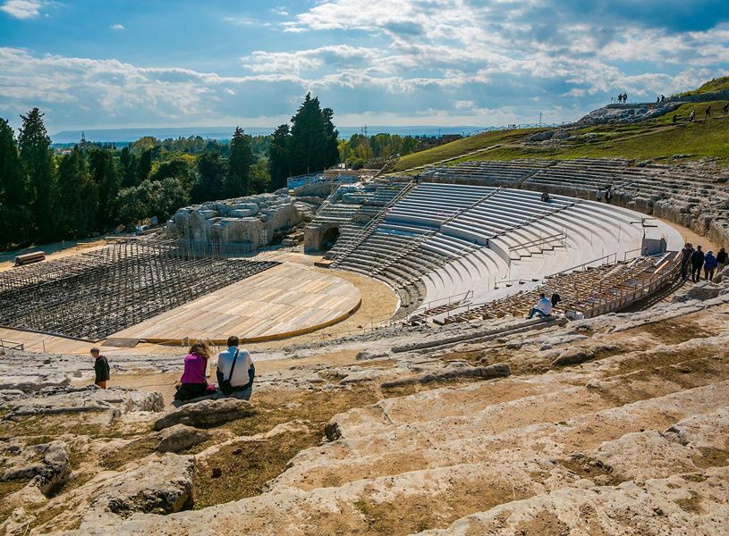 Ancient Greek amphitheatre and scenic green landscape in Syracuse 