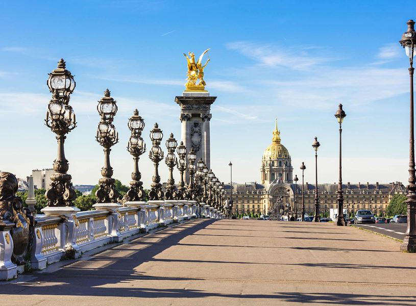 Pont Alexandre III with ornate lamps, golden statue and Les Invalides dome