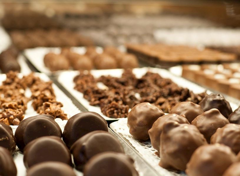 Assorted chocolate truffles and confections displayed on trays in Bruges, Belgium