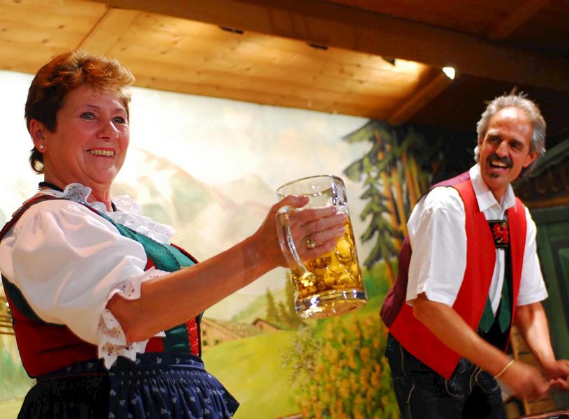 Entertainers in national costumes with beer in Innsbruck, Austria