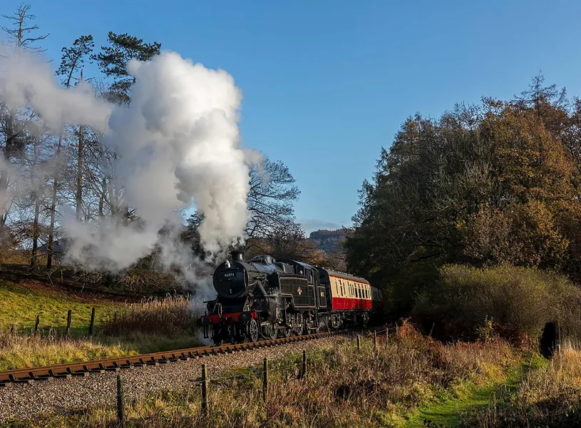 A steam train driving through the English Lake District