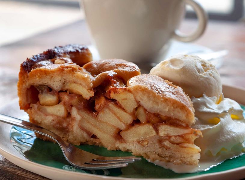 Slice of Dutch apple pie with vanilla ice cream