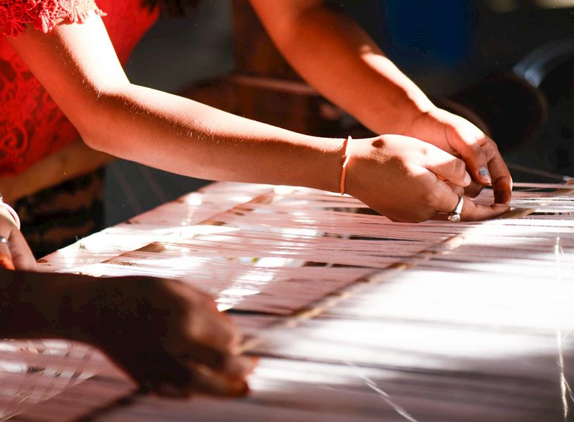 Artisans hands busy weaving traditional silk in Varanasi, India