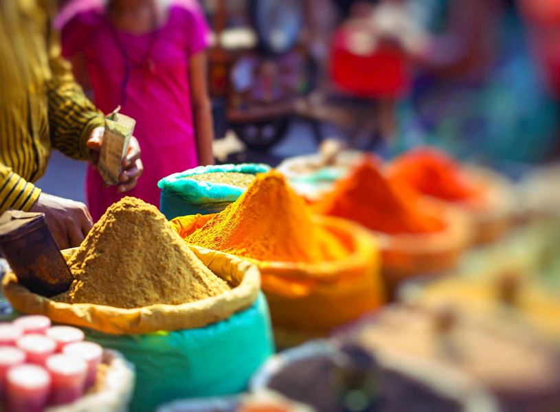 Vibrant yellow, orange and red powders displayed at market stalls in Kumarakom, India
