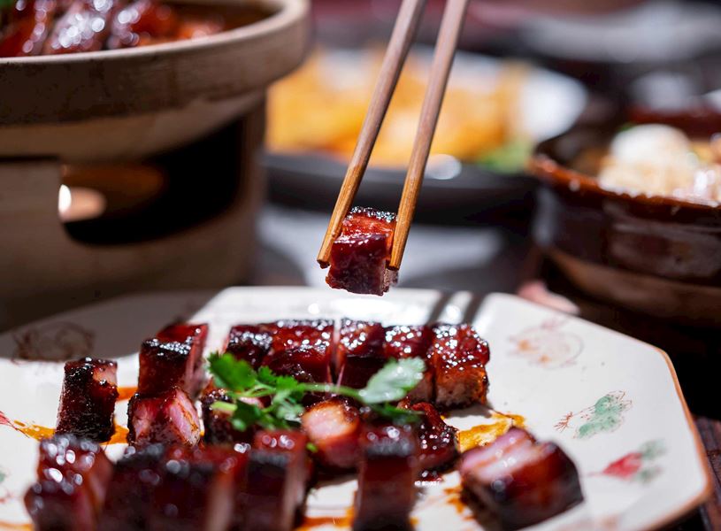 Sauce coated meat picked with chopsticks, Beijing, China