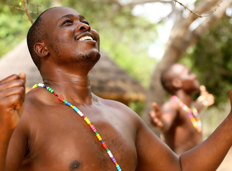 Shangaan villagers dancing, adorned with traditional jewellery, Kruger National Park, South Africa