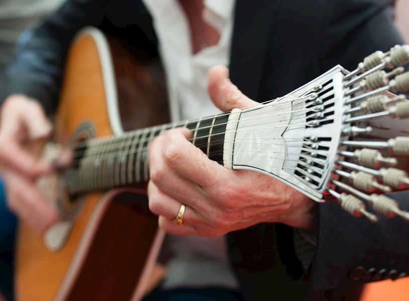 Close-up of Portuguese guitar being played during traditional Fado music performance