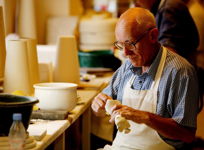 Craftsman shaping pottery piece at Belleek Pottery Visitor Centre