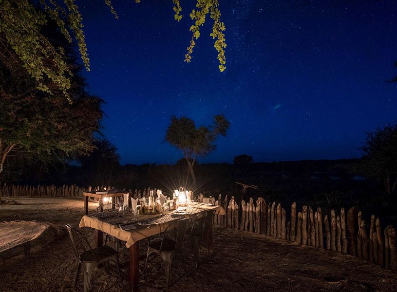 Dining beneath stars with African bush as backdrop, Maasai Mara, Kenya