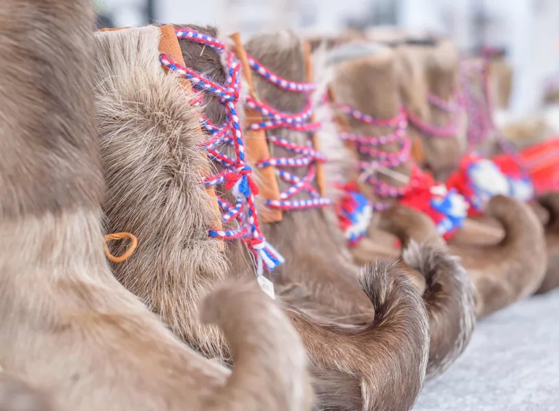 Traditional Sámi fur lined boots with colourful laces in Inari, Finland