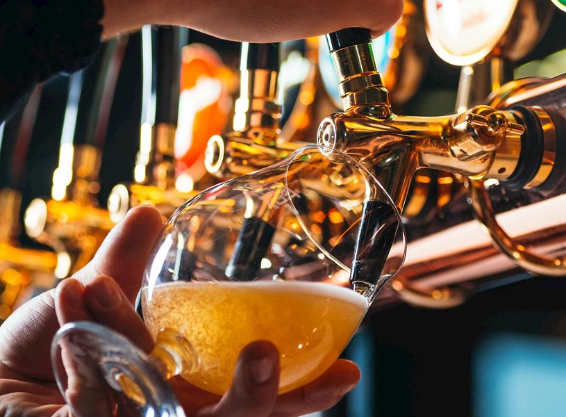 Draft beer being poured into glass in Antwerp, Belgium