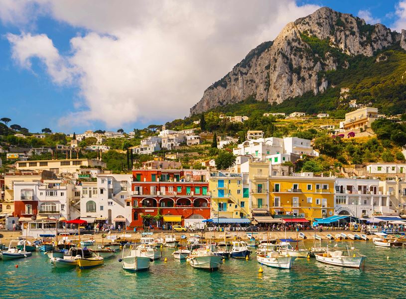 Colourful waterfront buildings and boats in Marina Grande harbour on Capri Island.