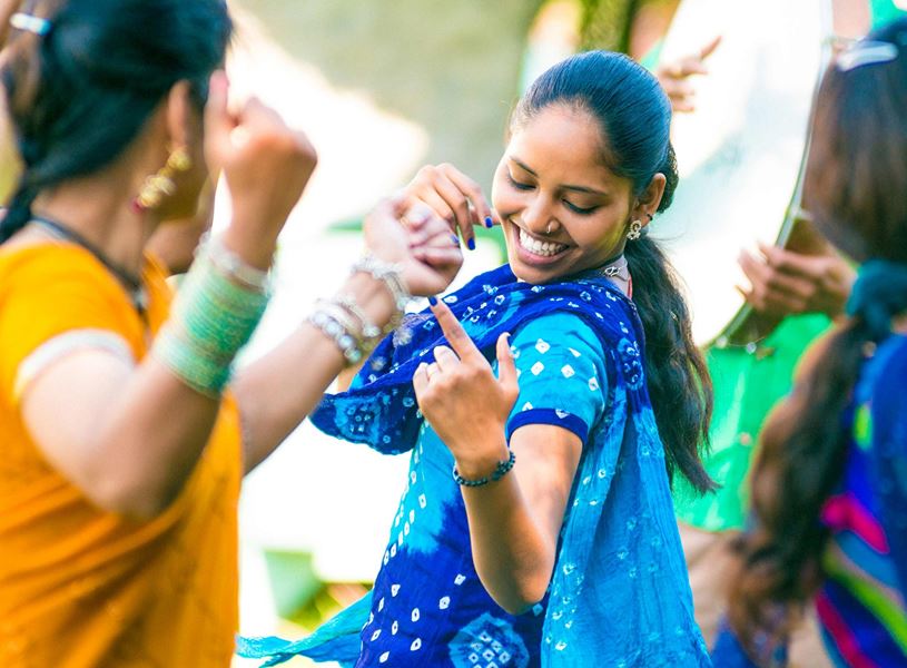 Dancers performing Kathak with joyful expressions in India