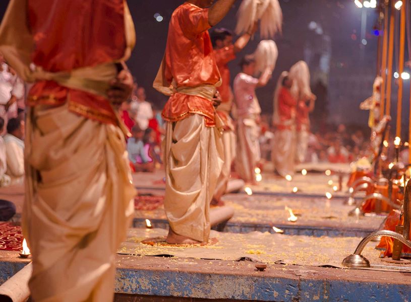 Hindu priests performing evening Ganga Aarti ceremony with lamps and rituals, Delhi, India