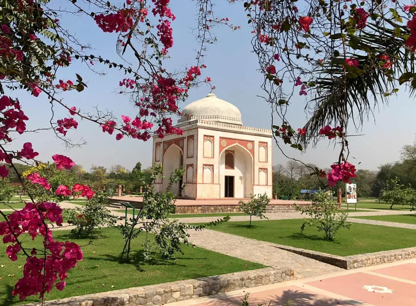 Exterior view of Sunder Nursery framed by blossoming branches, Delhi, India