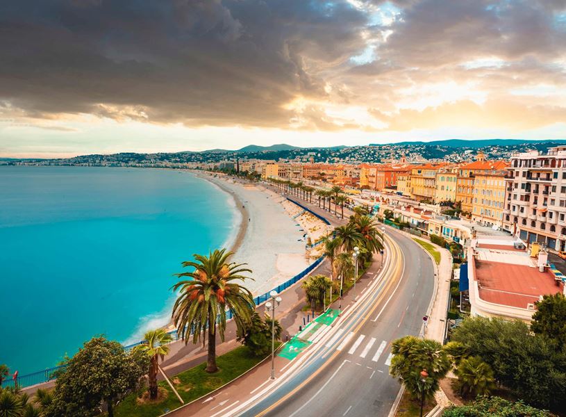 Coastal town with palm trees along a beach in Nice, France