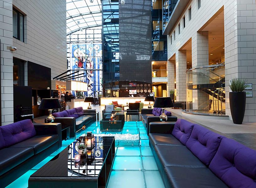 Grand Hotel Reykjavik lobby with modern seating, glass floor and artwork