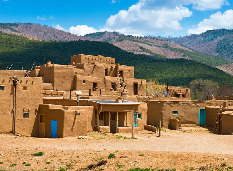 See the iconic, multi-storied adobe buildings in Taos Pueblo, USA