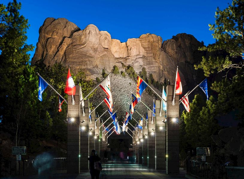 Visit Mount Rushmore’s outdoor amphitheater for an evening lighting ceremony, USA