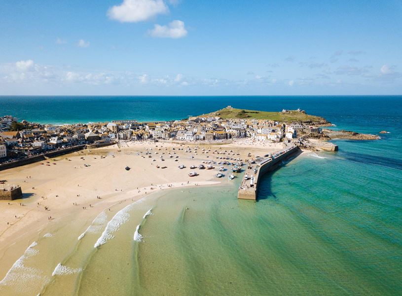 Aerial view of St. Ives beach, harbour and coastal townscape