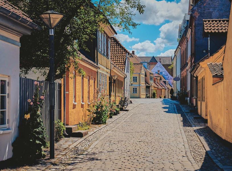 Colourful street with historic buildings in Odense, Denmark