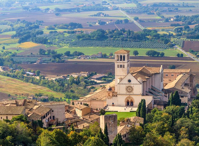 Basilica of Saint Francis in Assisi surrounded by countryside fields