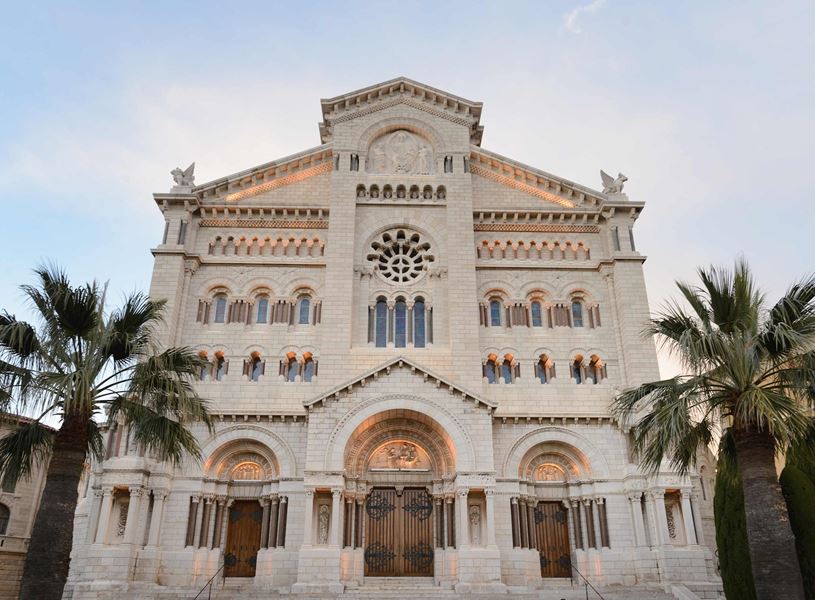 Monaco Cathedral facade with palm trees 