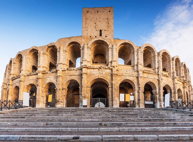 Ancient Roman amphitheatre with stone arches in Arles, France