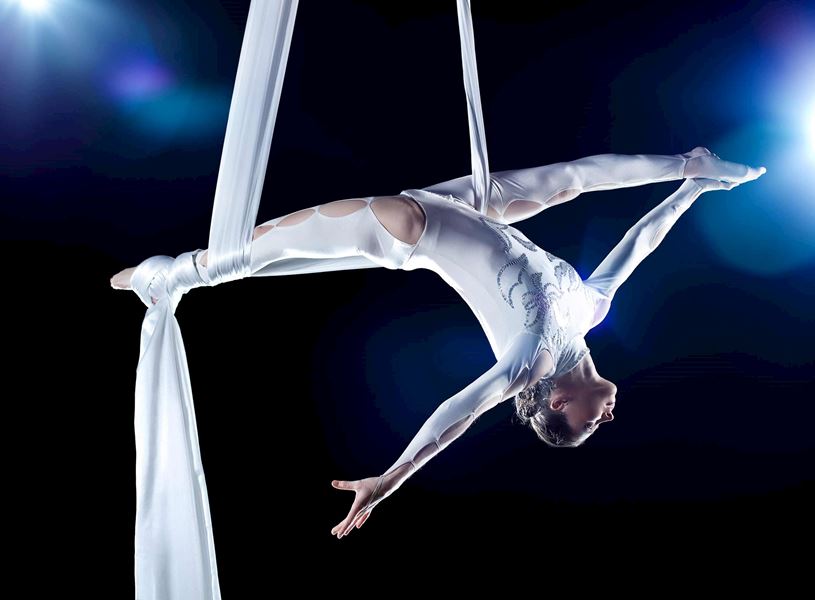 Performer suspended in air during acrobatic show, Shanghai, China