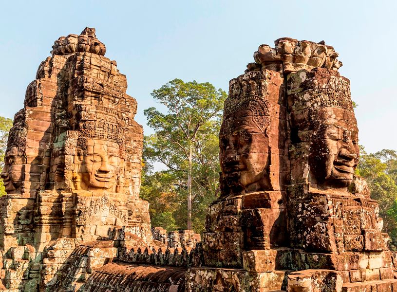 Ancient giant faces sculpted in stone at Angkor Archaeological Park, Cambodia