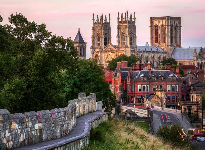 York Minster above historic cityscape at sunset in York, England 