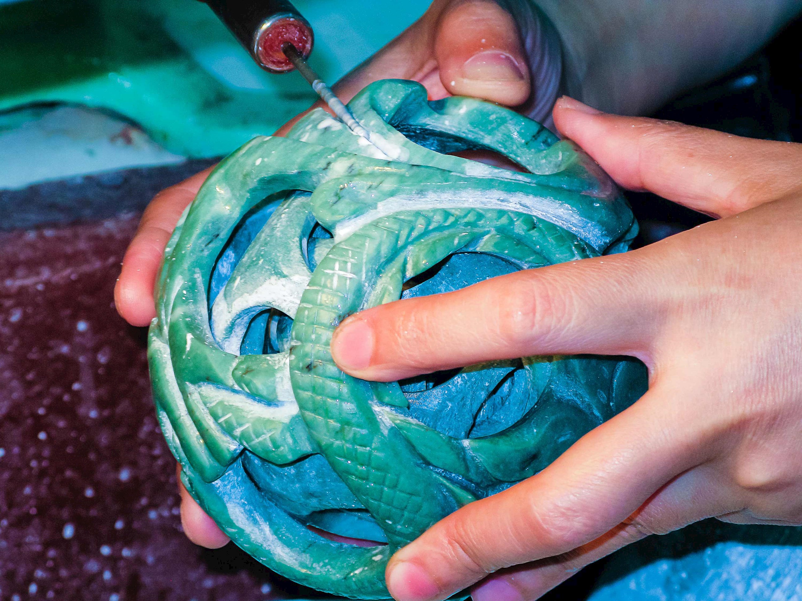 Hands presenting turquoise jade artifact from Xi’an, China