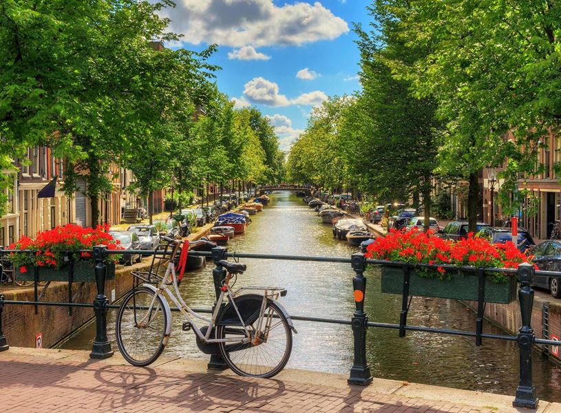 Bike by canal in Amsterdam, Netherlands