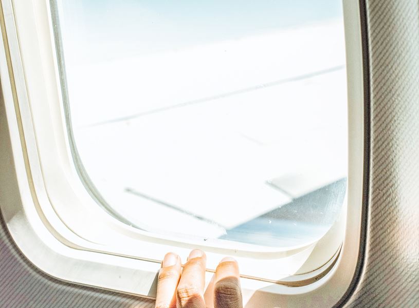 A window view of the wing of the Plane during a flight