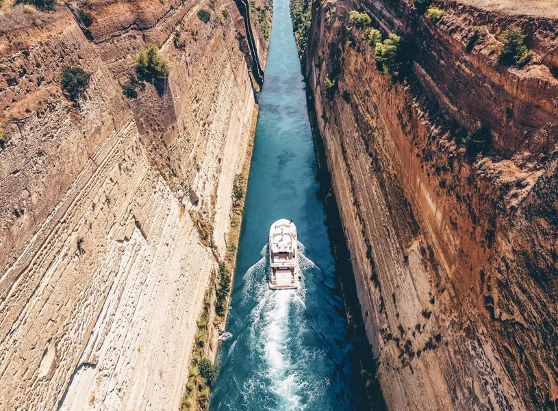 View of the Corinth Canal and a boat passing through in Greece.