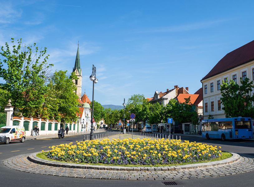  Zagreb roundabout with flowers, historic buildings and church spire