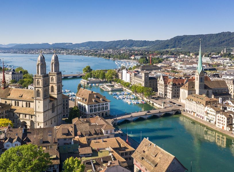 See the Grossmunster and the Fraumunster in Zurich, Switzerland